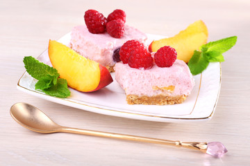 Cake with fruits and berries on plate on wooden background