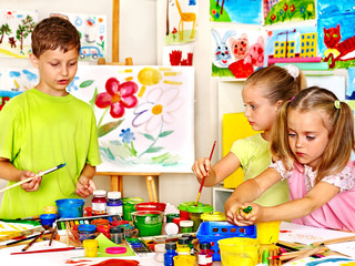 Child painting at easel.