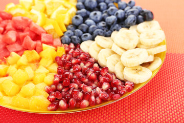 Sliced fruits on plate on table