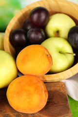 Naklejka na ściany i meble Ripe fruits in bowl on table close up