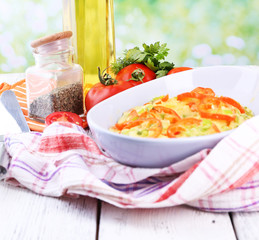 Casserole with vegetables in bowl  on natural background