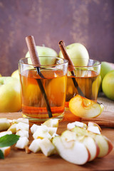 still life with apple cider and fresh apples on wooden table