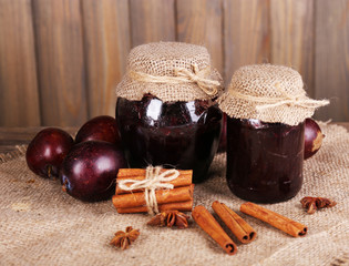 Tasty plum jam in jars and plums
