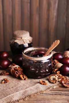 Tasty plum jam in jars and plums