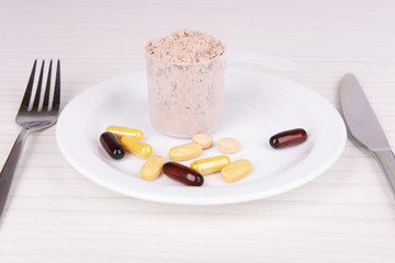 Whey protein powder in scoop with vitamins