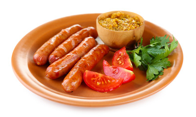 Tasty thin sausages on plate isolated on white