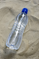 a water bottle in the sand