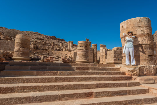 tourist standing roman temple in Nabatean city of  Petra Jordan