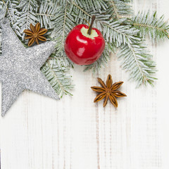 Christmas decoration with twigs, baubles, silver star and snow
