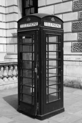 Fototapeta premium Traditional telephone booth in London, black and white photo