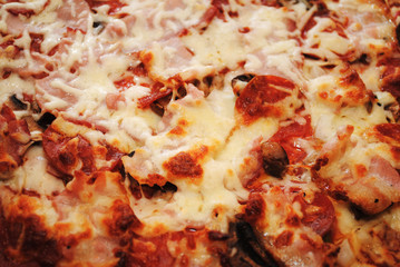 Close Up of a Cooked Bacon and Pepperoni Pizza