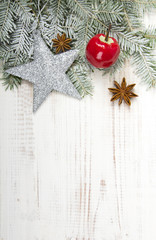 Christmas decoration with twigs, baubles, silver star and snow