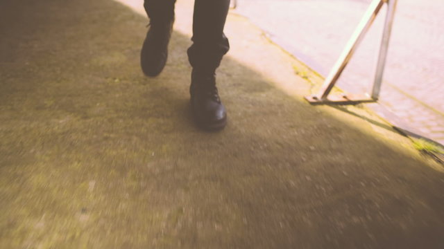 Man Walking in urban area wearing boots