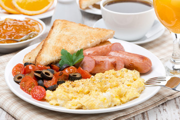 scramble eggs with tomatoes, sausage and toast for breakfast