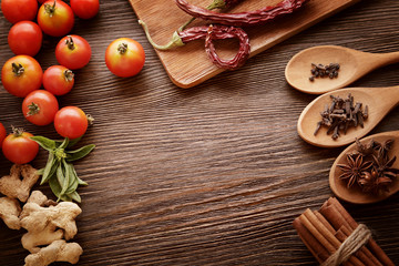 spices and vegetables in anticipation of cooking on a wooden tab