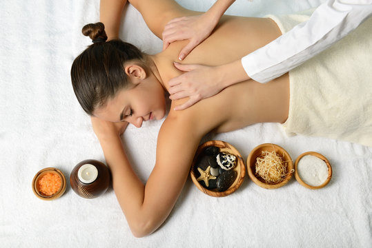 portrait of young beautiful woman in spa environment gets massag