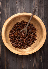 Roasted beans coffee in old wooden bowl