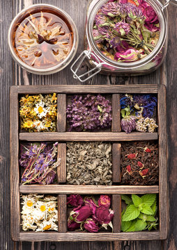 Dried herbs in vintage box and tea