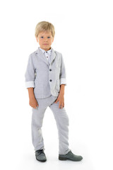 fashion little boy in gray suit posing at studio over white