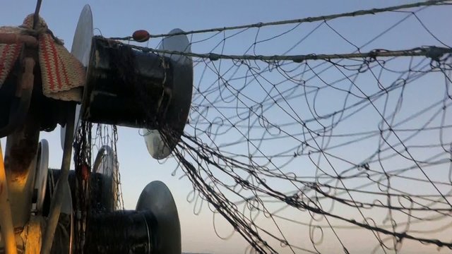 Picking up the nets on fishing boat