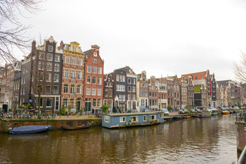 Fototapeta na wymiar Dutch canals and typical canalside houses in Amsterdam