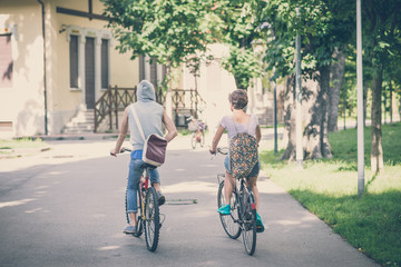 Fototapeta premium couple of friends young man and woman riding bike