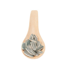 sunflower seeds on wooden spoon isolated with white background.