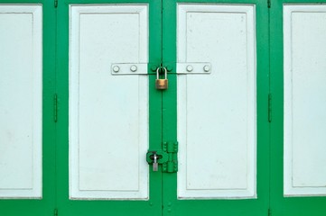 Old Brass Padlock on Wooden Green Gate