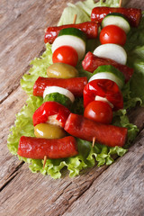 hot grilled sausages with vegetables on skewers vertical