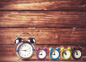 Retro alarm clocks on a table. Photo in retro color image style
