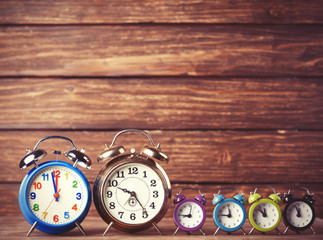 Retro alarm clocks on a table. Photo in retro color image style