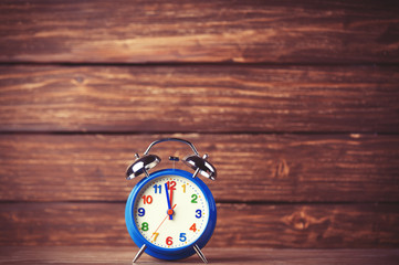 Retro alarm clock on wooden background
