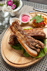 Pork ribs on wooden plate
