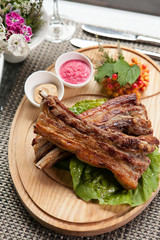 Pork ribs on wooden plate