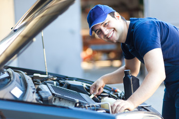 Professional car mechanic working in auto repair service.