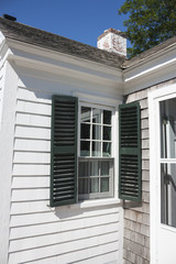 White Cape Cod house with green shutters in Massachusetts