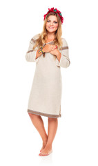 Young beautiful smiling girl in Ukrainian costume on the white