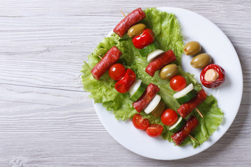 grilled sausages with vegetables on a plate top view