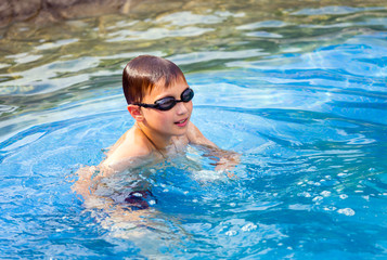 Ten year old boy in swimming pool