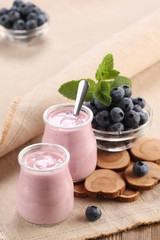 Obraz na płótnie Canvas yogurt with blueberries in a glass jar and blueberries in a glas
