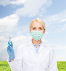 doctor in mask holding syringe with injection