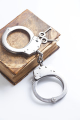 handcuffs and book of law 