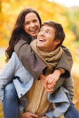 Fototapeta premium smiling couple hugging in autumn park