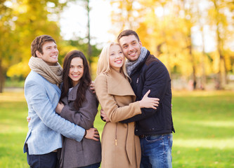 Fototapeta premium group of smiling men and women in autumn park