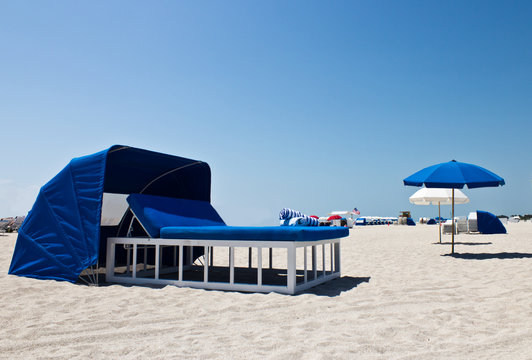 Luxurious beach bed with canopy on a sandy beach