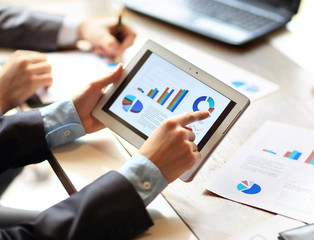 work of two young businessmen using touchpad