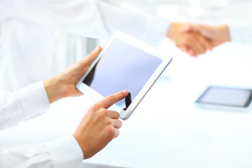 Business associates shaking hands in office