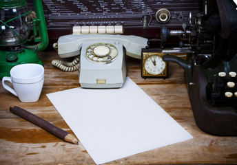 Still life with retro typewriter, alarm clock, telephone and old