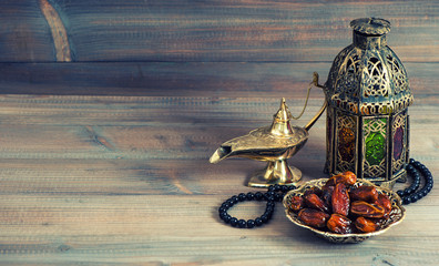 Fototapeta na wymiar Dates, arabian lantern and rosary. Islamic holiday