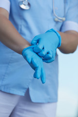 Fototapeta premium woman doctor wears medical gloves